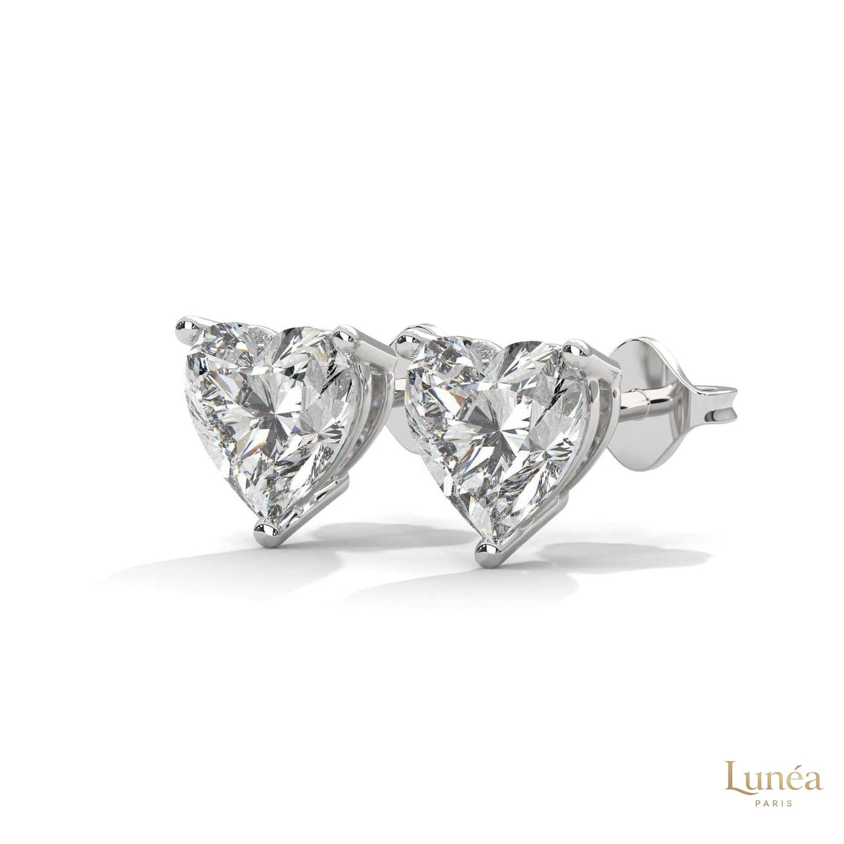 1.25 CT heart-shaped lab-grown diamond stud earrings set in polished 14K white gold with a secure three-prong setting.