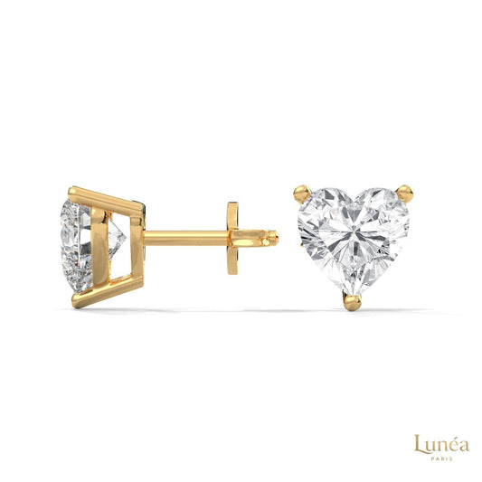 1.25 carat heart-shaped lab-grown diamond stud earrings set in polished 14K yellow gold with a secure three-prong setting.