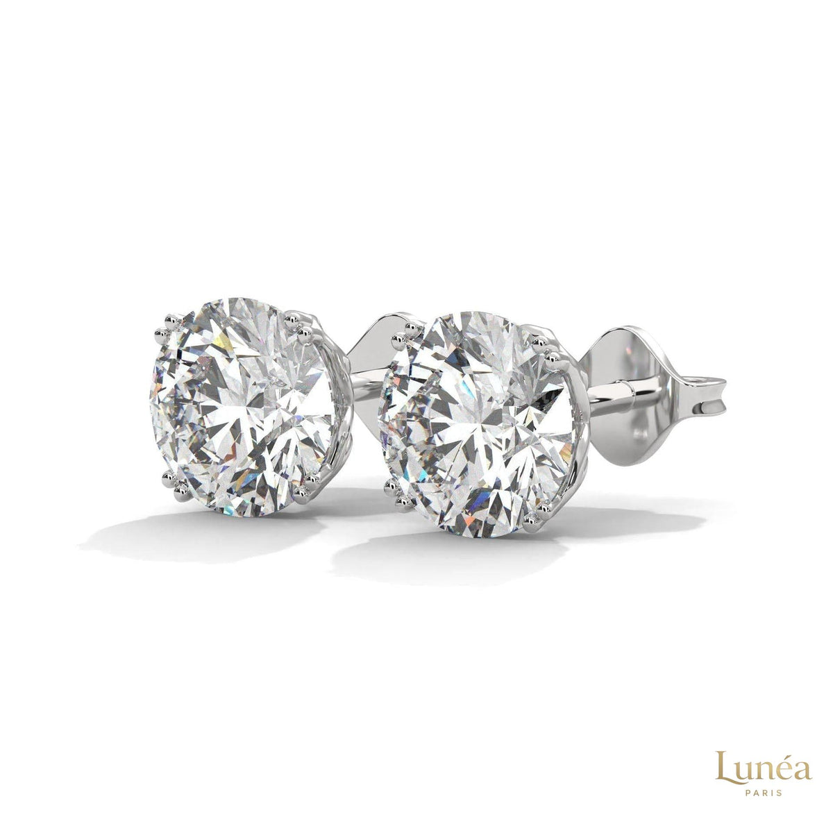 1.30 carat round lab-grown diamond stud earrings set in polished 14K white gold with a classic four-prong setting.
