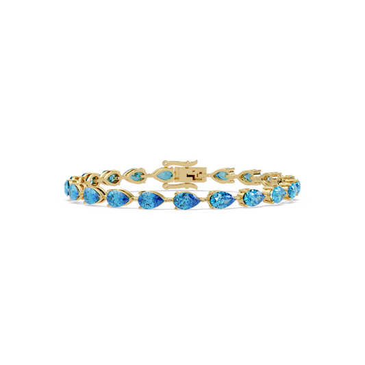 Pear-cut aquamarine blue colorstone tennis bracelet in yellow gold