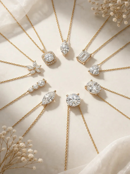 Collection of delicate gold necklaces featuring various diamond-cut pendants arranged in a circle on a white surface.