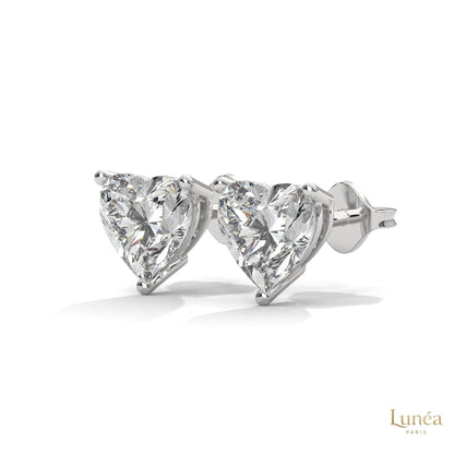 1.25 CT heart-shaped lab-grown diamond stud earrings set in polished 14K white gold with a secure three-prong setting.