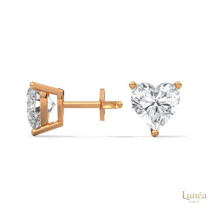 1.25 CT heart-shaped lab-grown diamond stud earrings set in polished 14K rose gold with a secure three-prong setting.