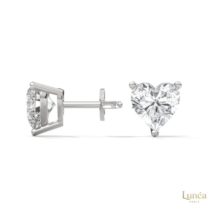 1.25 CT heart-shaped lab-grown diamond stud earrings set in polished 14K white gold with a secure three-prong setting.
