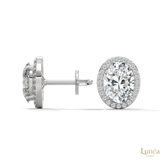 1.25 CT oval lab-grown diamond stud earrings in 14K white gold with a pavé halo setting.