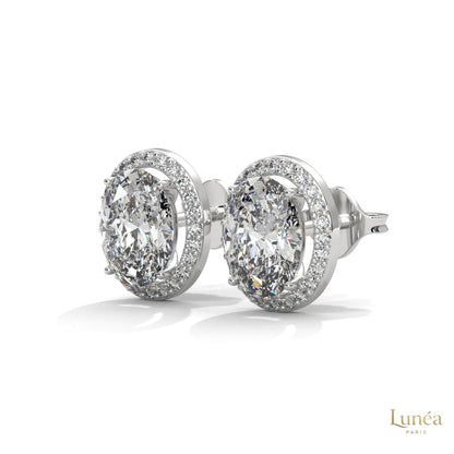 1.25 CT oval lab-grown diamond stud earrings in a pavé halo setting, available in 14K gold or platinum.