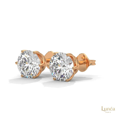 1.30 CT round lab-grown diamond stud earrings in a classic 6-prong 14K gold setting.