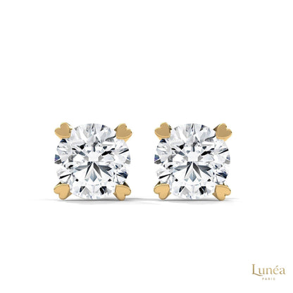 1.30 CT lab-grown diamond stud earrings featuring delicate heart-shaped prongs in polished 14K gold.