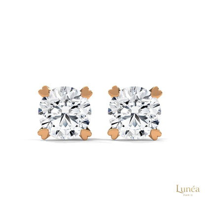 1.30 CT lab-grown diamond stud earrings featuring delicate heart-shaped prongs in polished 14K gold.