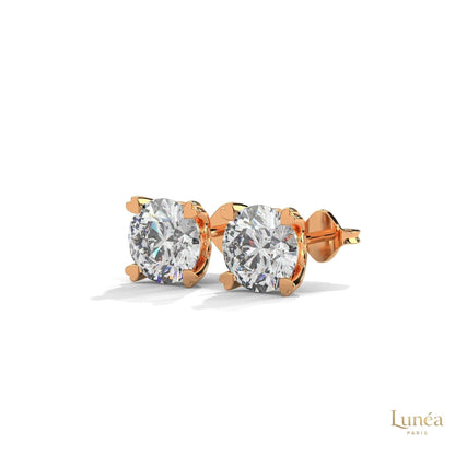 1.30 CT lab-grown diamond stud earrings featuring delicate heart-shaped prongs in polished 14K gold.