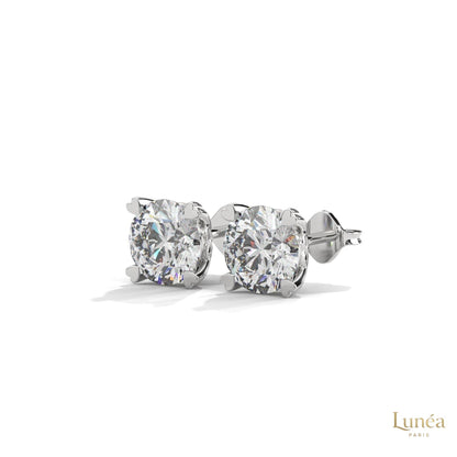 1.30 CT lab-grown diamond stud earrings featuring delicate heart-shaped prongs in polished 14K gold.