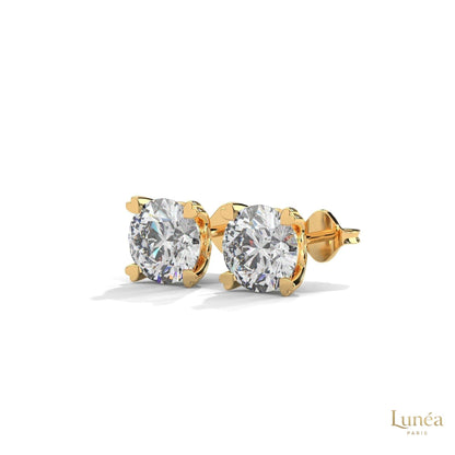 1.30 CT lab-grown diamond stud earrings featuring delicate heart-shaped prongs in polished 14K gold.