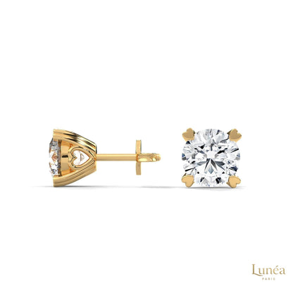 1.30 CT lab-grown diamond stud earrings in 14K gold featuring delicate heart-shaped prongs and a brilliant round cut.