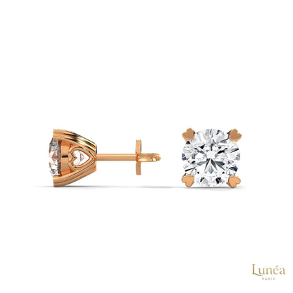 1.30 CT lab-grown diamond stud earrings in 14K rose gold with delicate heart-shaped prongs.