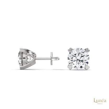 1.30 CT lab-grown diamond stud earrings in 14K white gold with delicate heart-shaped prongs.