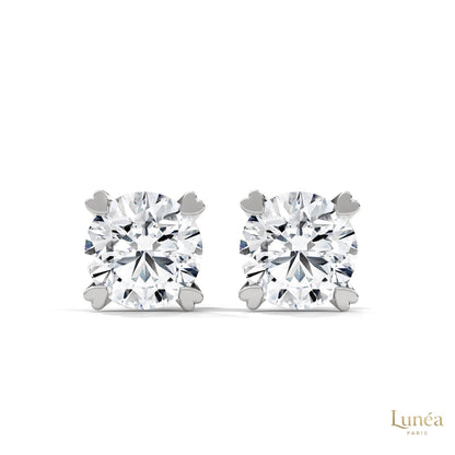 1.30 CT lab-grown diamond stud earrings featuring delicate heart-shaped prongs in polished 14K gold.