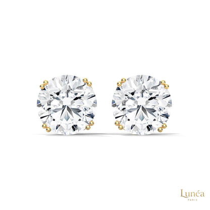 1.30 carat round lab-grown diamond stud earrings set in a classic four-prong 14K white gold setting.