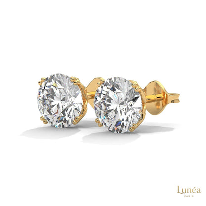 1.30 CT round lab-grown diamond stud earrings in a classic four-prong setting, available in 14K gold or platinum.