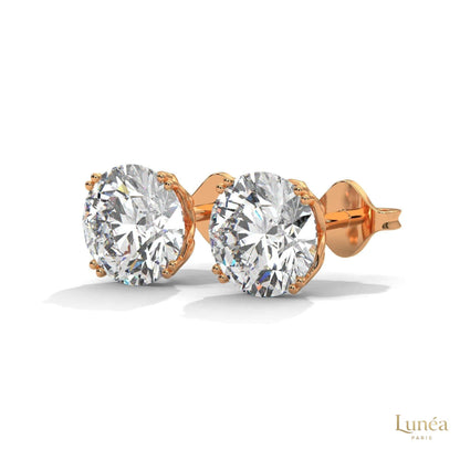 1.30 carat round lab-grown diamond stud earrings set in a classic four-prong 14K white gold setting.