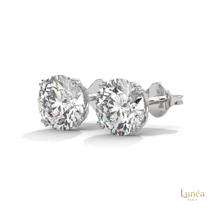 1.30 carat round lab-grown diamond stud earrings set in polished 14K white gold with a classic four-prong setting.
