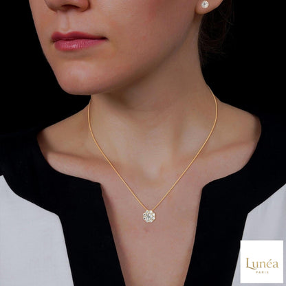 Model wearing 3.25 CT floral cluster lab-grown diamond earrings and matching pendant in 14K gold.
