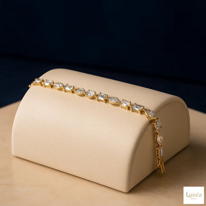 “Luxury 14K gold bracelet with lab-grown diamonds in pear, marquise, emerald, oval, and round shapes, elegant sustainable fine jewelry.”