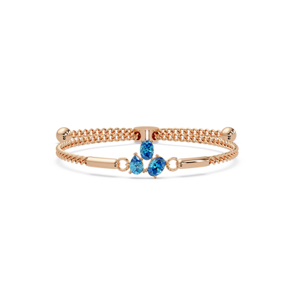 Three-stone pear and oval colorstone hinged bangle in rose gold with aquamarine stones