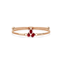 Three-stone pear and oval colorstone hinged bangle in rose gold with red stones