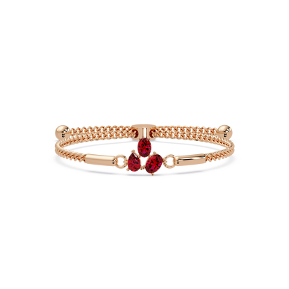 Three-stone pear and oval colorstone hinged bangle in rose gold with red stones