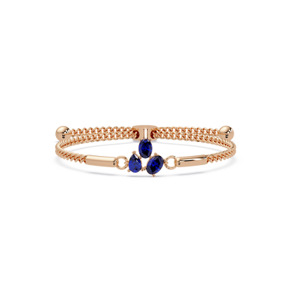 Three-stone pear and oval colorstone hinged bangle in rose gold with sapphire stones