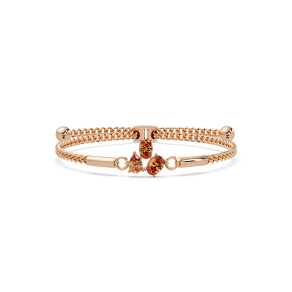 Three-stone pear and oval colorstone hinged bangle in rose gold with topaz stones