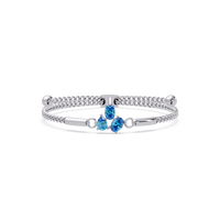 Three-stone pear and oval colorstone hinged bangle in white gold with aquamarine stones