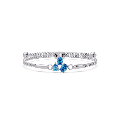 Three-stone pear and oval colorstone hinged bangle in white gold with aquamarine stones