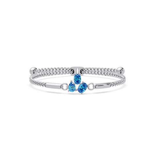 Three-stone pear and oval colorstone hinged bangle in white gold with aquamarine stones