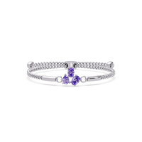 Three-stone pear and oval colorstone hinged bangle in white gold with purple stones