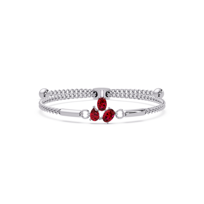 Three-stone pear and oval colorstone hinged bangle in white gold with red stones