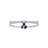 Three-stone pear and oval colorstone hinged bangle in white gold with sapphire stones
