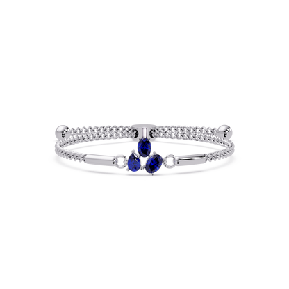Three-stone pear and oval colorstone hinged bangle in white gold with sapphire stones