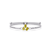 Three-stone pear and oval colorstone hinged bangle in white gold with yellow stones