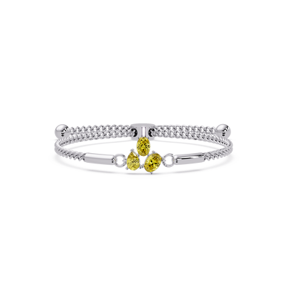 Three-stone pear and oval colorstone hinged bangle in white gold with yellow stones