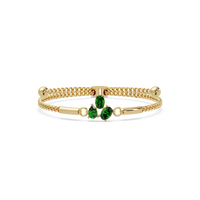 Three-stone pear and oval colorstone hinged bangle in yellow gold with green stones