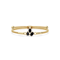 Three-stone pear and oval colorstone hinged bangle in yellow gold with onyx stones