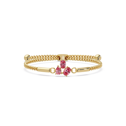 Three-stone pear and oval colorstone hinged bangle in yellow gold with pink stones