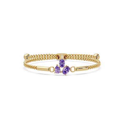 Three-stone pear and oval colorstone hinged bangle in yellow gold with purple stones