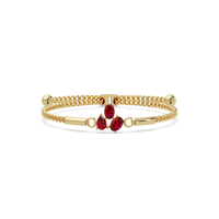 Three-stone pear and oval colorstone hinged bangle in yellow gold with red stones