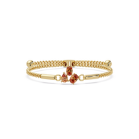Three-stone pear and oval colorstone hinged bangle in yellow gold with topaz stones