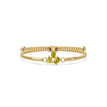 Three-stone pear and oval colorstone hinged bangle in yellow gold with yellow stones
