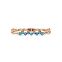 Nine princess-cut aquamarine colorstones in a rose gold chain-accent cuff bracelet