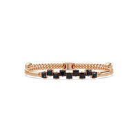 Nine princess-cut onyx colorstones in a rose gold chain-accent cuff bracelet