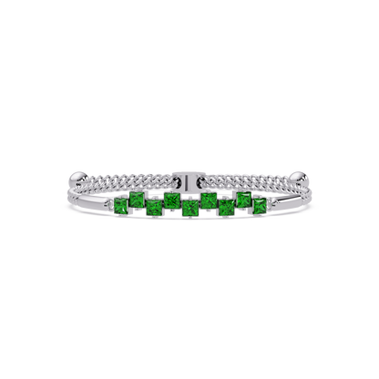 Nine princess-cut green colorstones in a white gold chain-accent cuff bracelet